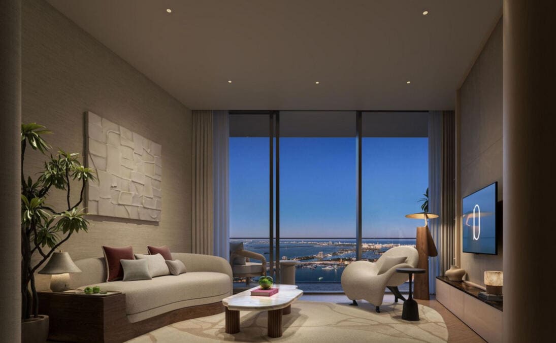 Elegant lounge at dusk with curved seating and floor-to-ceiling bay views